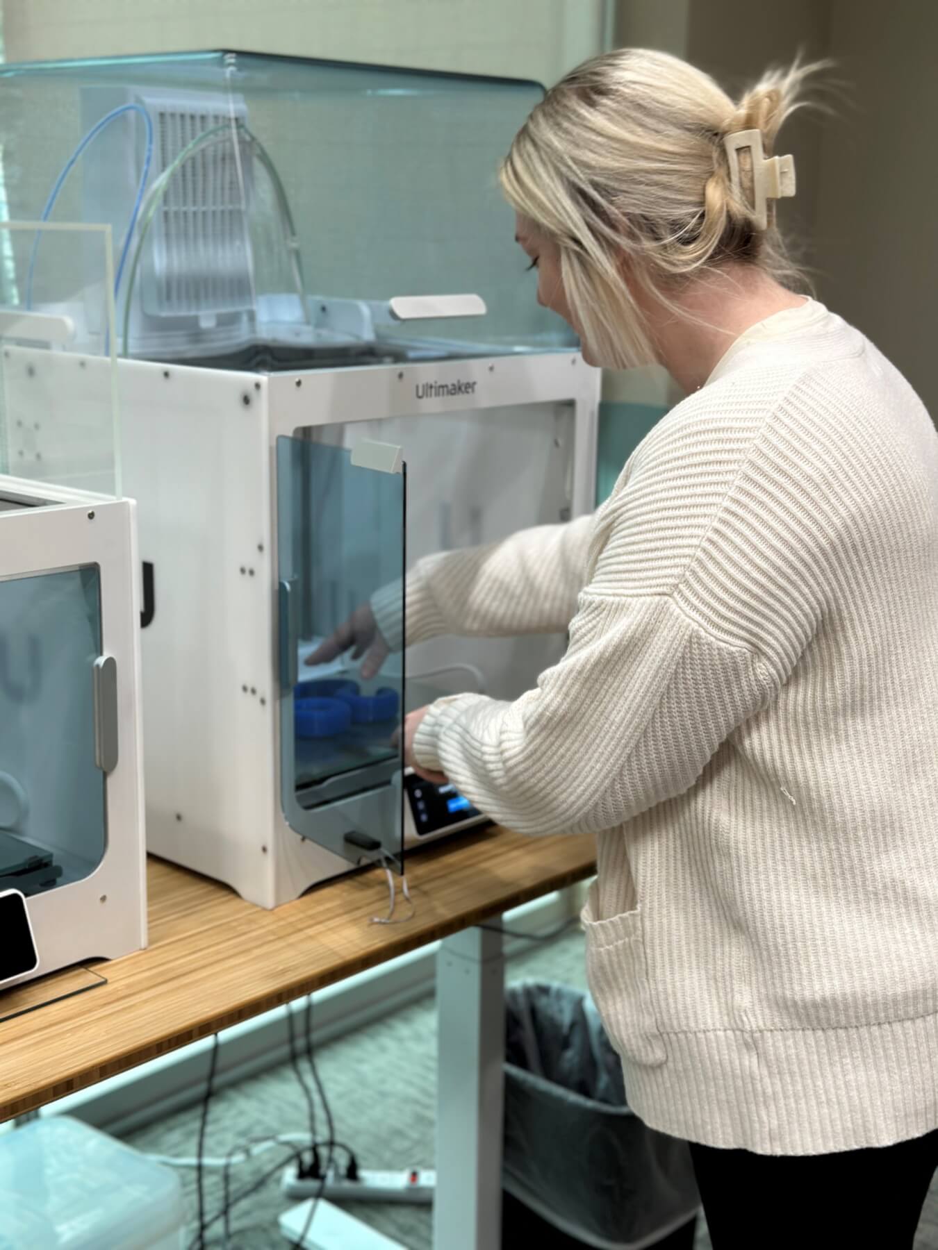 Courtney removing a finished print from 3D printer
