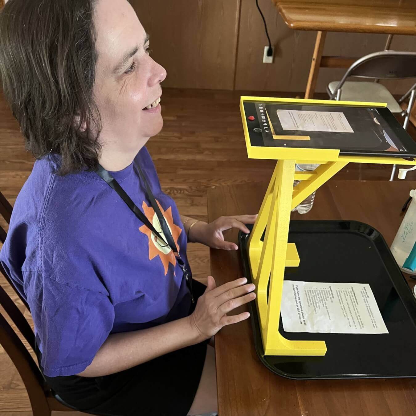 woman with visual impairment using 3d printed iPad stand for scanning documents