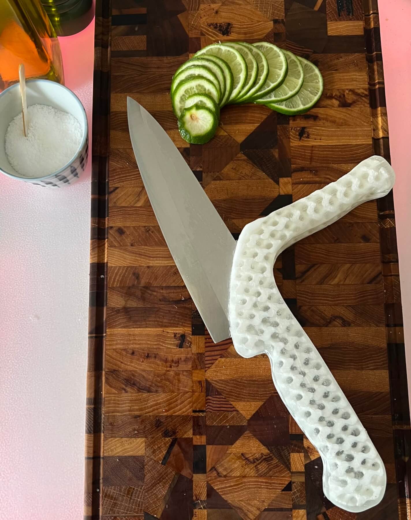 Adaptive knife on cutting board with sliced limes