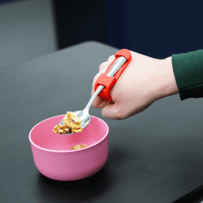 Feeding cuff in use walnuts on top of spoon